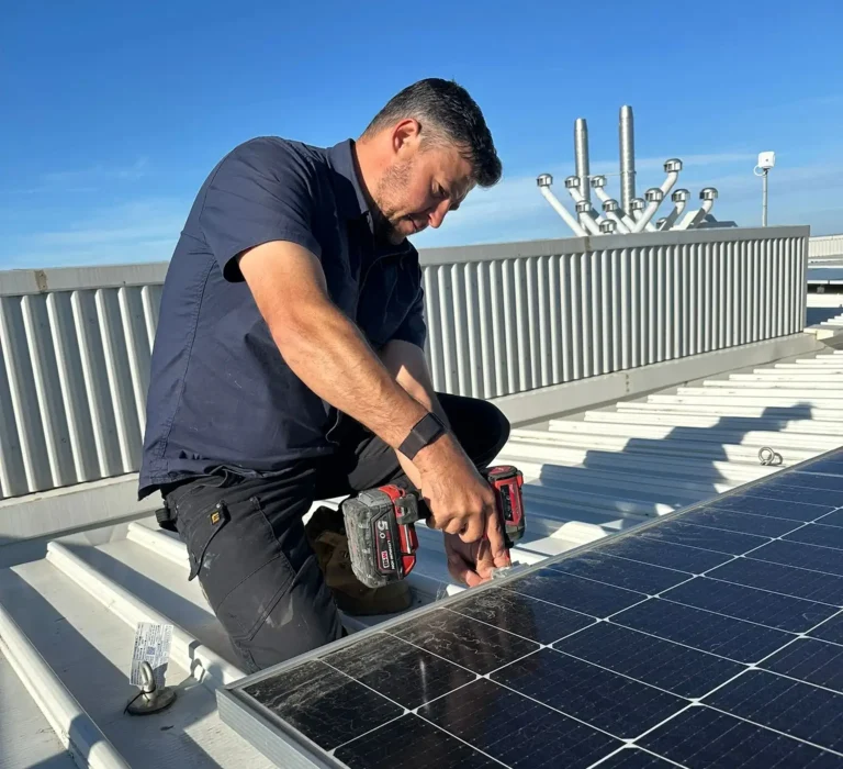 Technician servicing the mounting of an existing rooftop solar panel